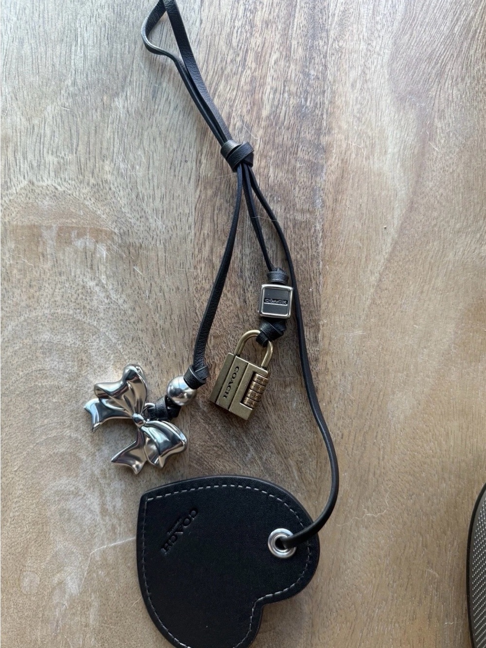 Coach Black Leather Heart Tag with Gold Lock and Silver Bow Charms